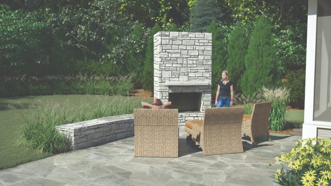 Outdoor patio with stone fireplace and seating area surrounded by greenery.